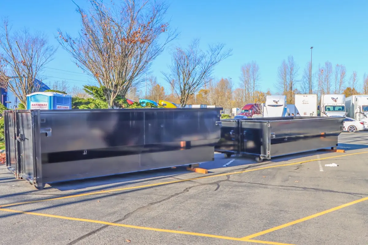 Professional dumpster rental service with roll-off container on residential driveway in Dripping Springs